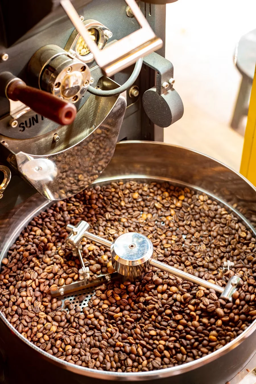 Freshly roasted coffee beans in the cooling tray of a small drum roaster