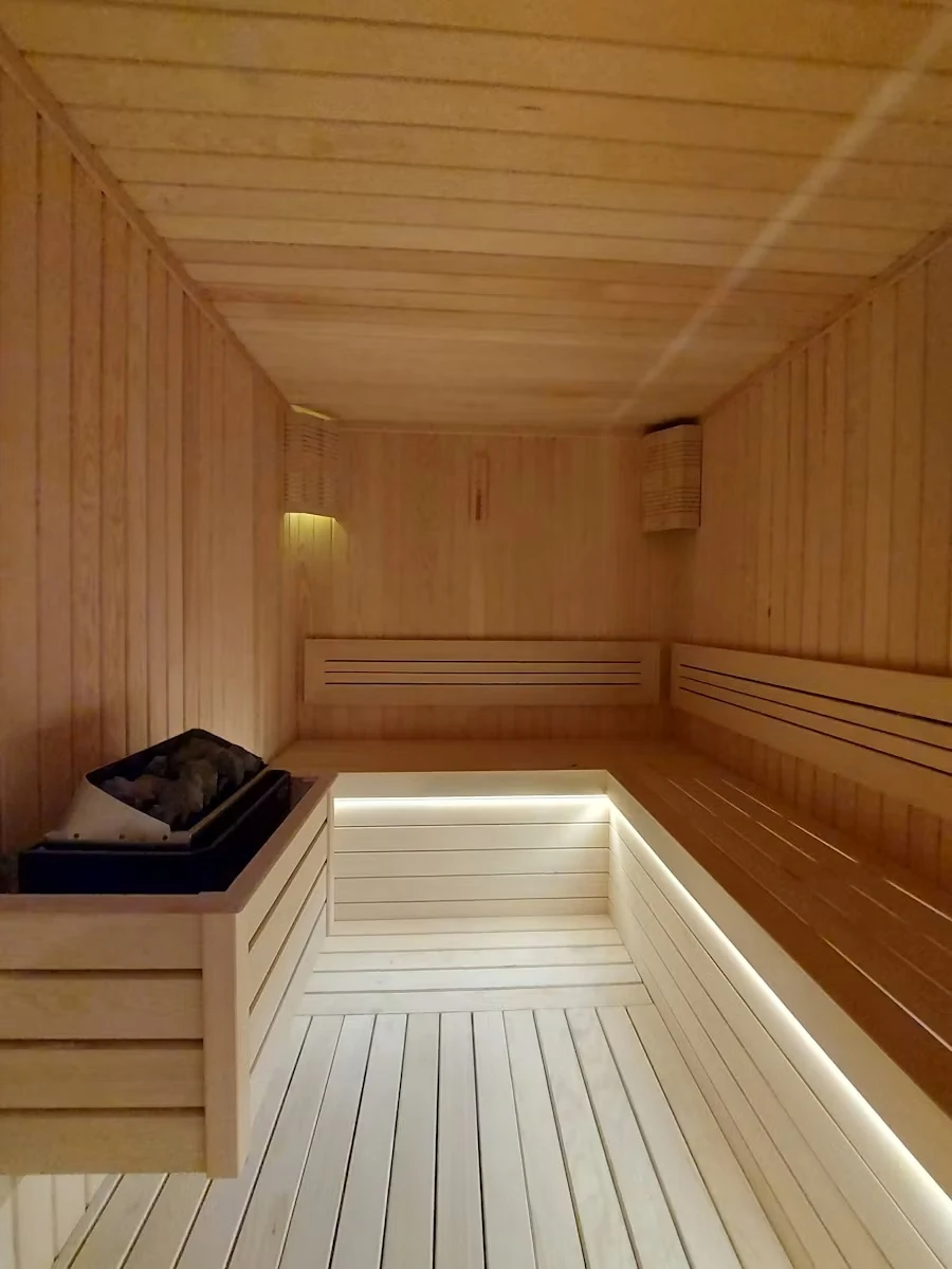 Empty wooden sauna with a softly lit bench