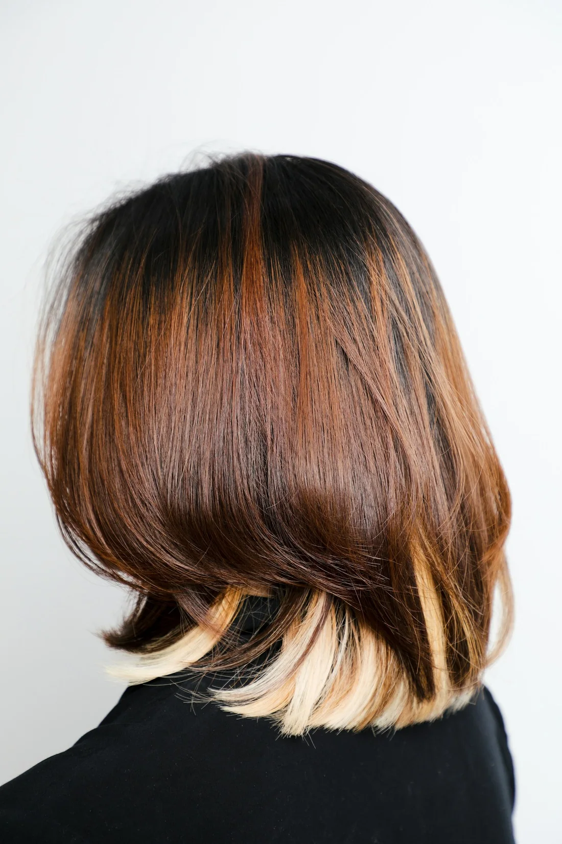 A glossy auburn bob with blonde ends