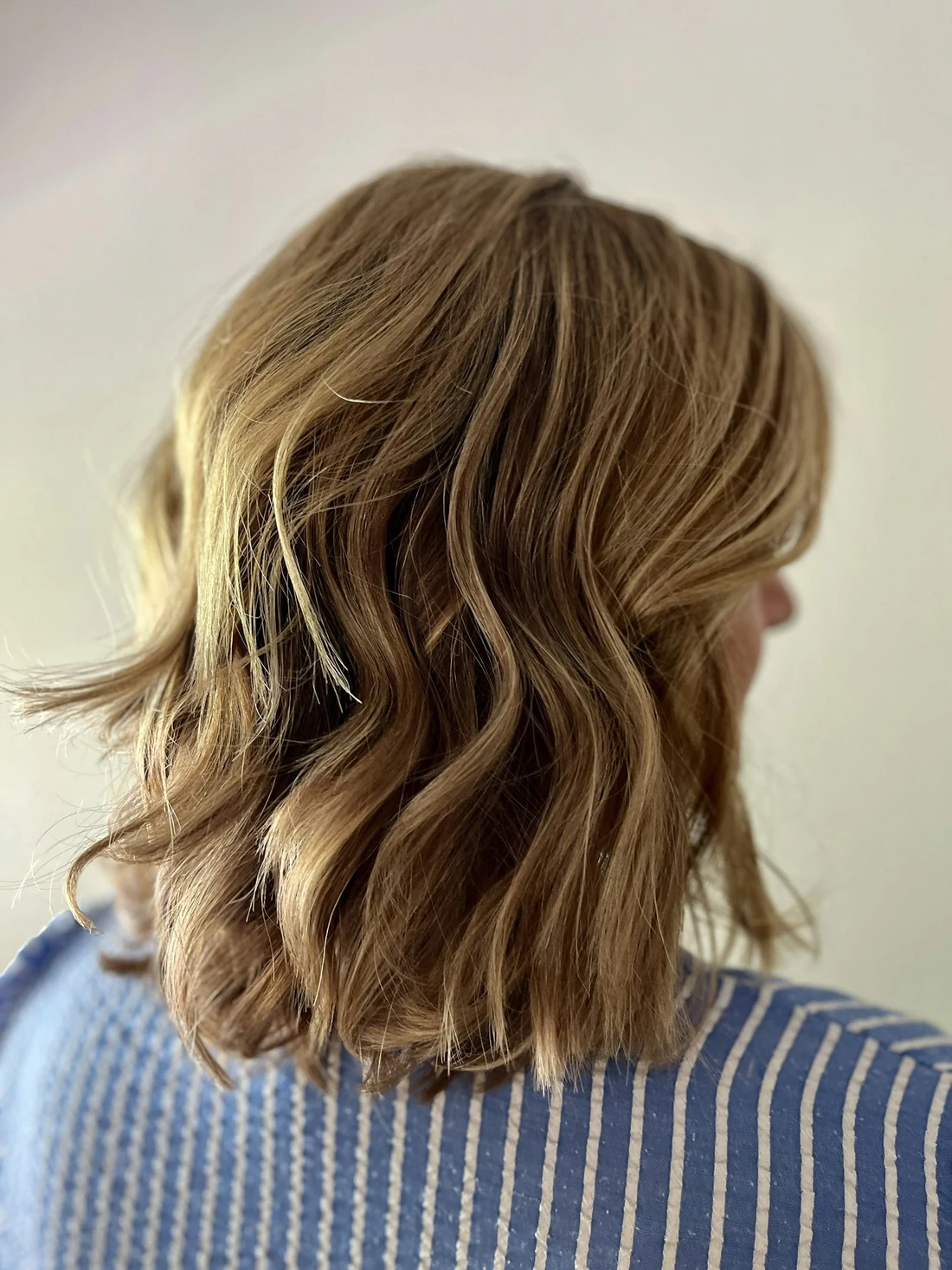A shoulder-length cut with sandy highlights